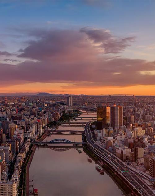 Image of a river running through a Japanese city