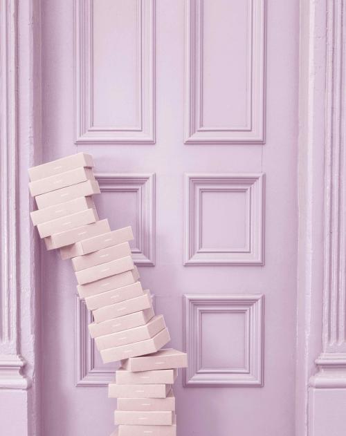 A stack of small cardboxes leaning against a decorative door