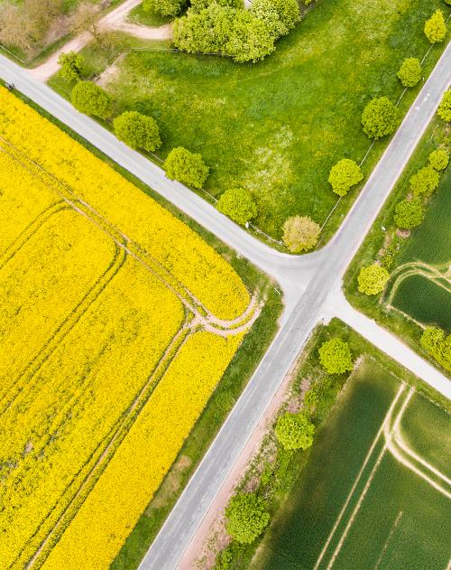 Image of two roads crossing in the countryside taken from high above with fields on all sides