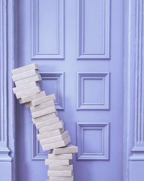 Image of small boxes stacked up in front of a door