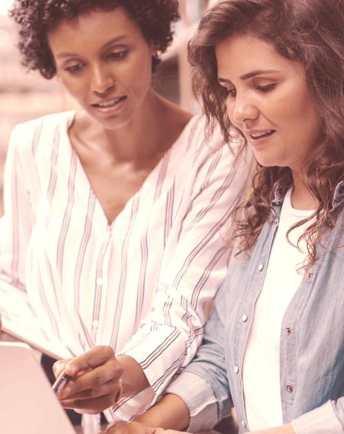 Two women looking at a laptop